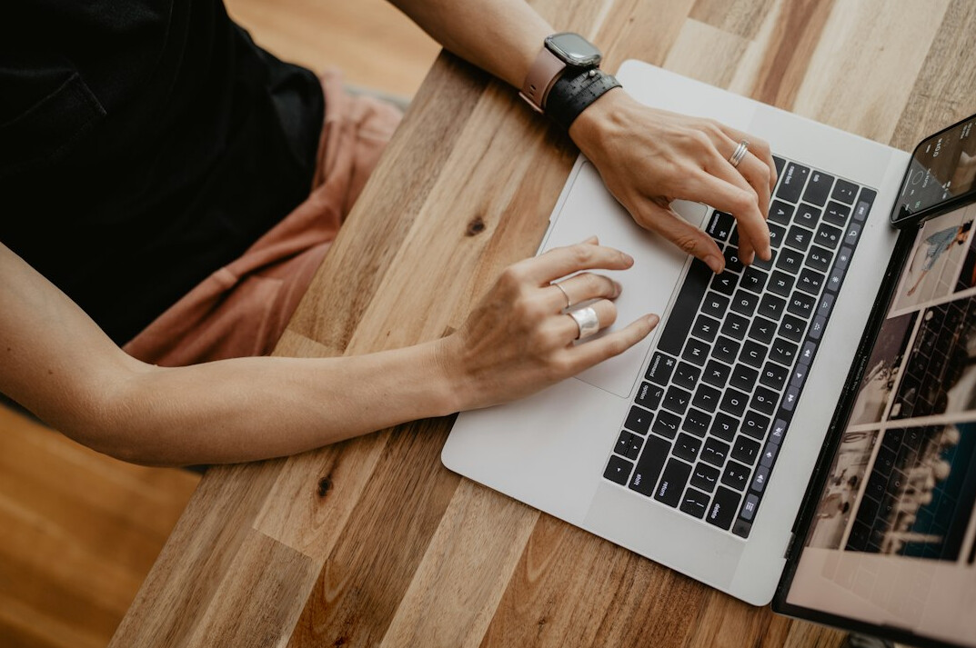 professional writing email on laptop